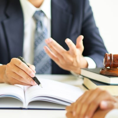 lawyer pointing to open book for client